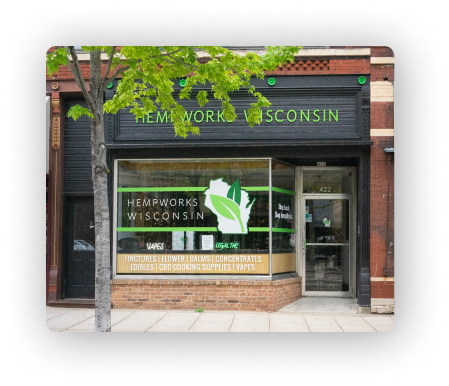 Hempworks Wisconsin Storefront, exterior has a large window and red brick.