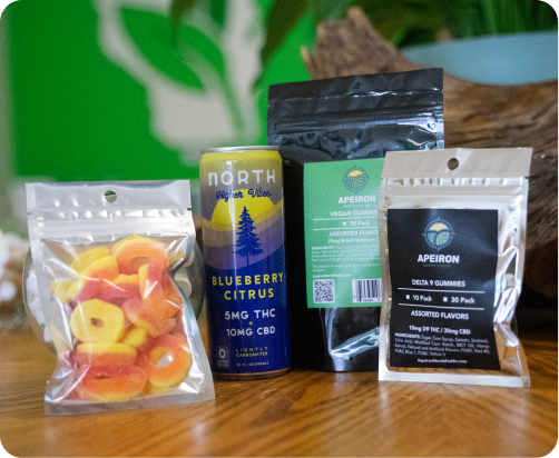Grouping of different edibles including a drink, peach rings, and two other packages.